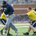 Former Michigan football player Gilvanni Johnson attempts to out run the reach of Rick Stites during the annual alumni flag football game before spring practice at Michigan Stadium on Saturday, April 13, 2013. Melanie Maxwell I AnnArbor.com